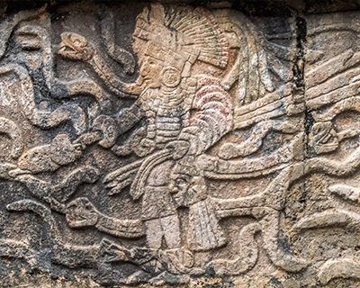 warrior holding head tzompantli platform of skulls chichen itza